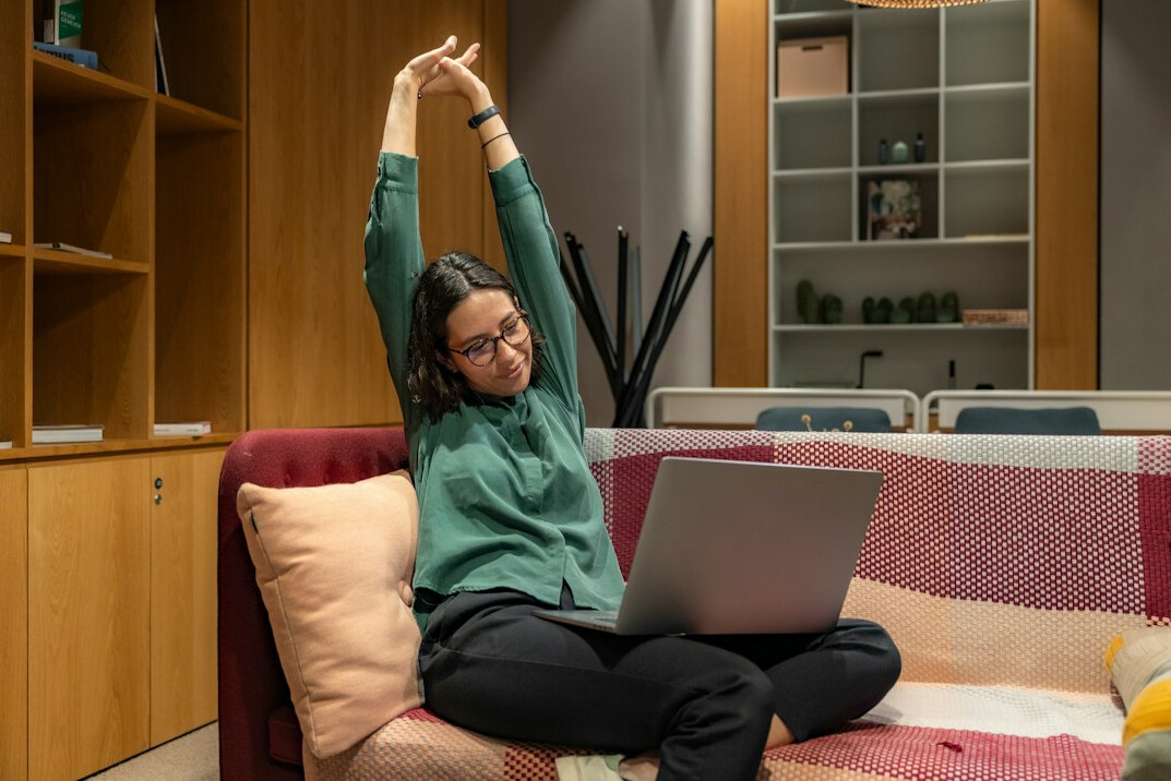person stretching in office